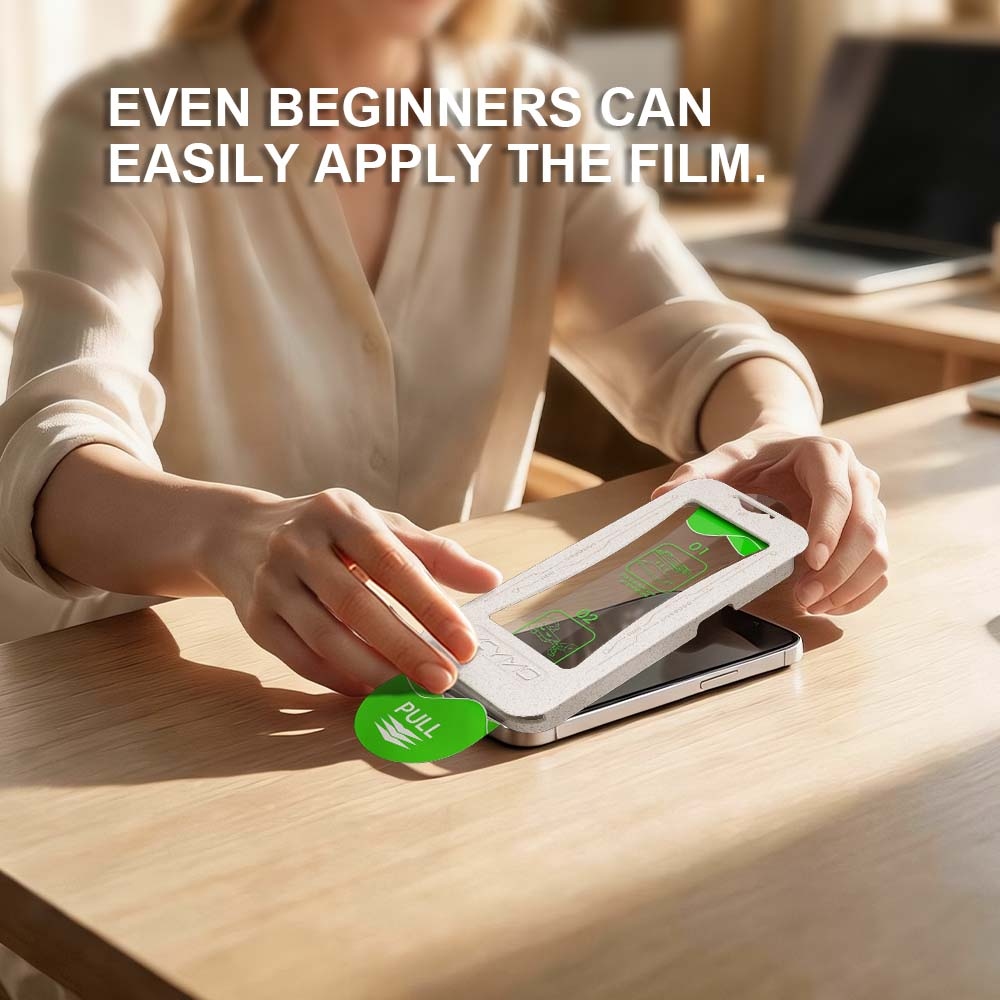 Woman using YCYMO alignment tool to install phone screen protector on wooden desk, beginner friendly application